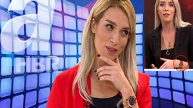 A Haber sunucusu bir serveti kolunda taşıyor